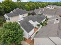 Aerial view of a residential neighborhood, showcasing well-maintained homes, mature trees, and a serene setting at 23 Caldwell, Pittsboro, NC 27312