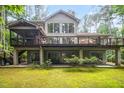 Spacious backyard with a multi-level deck, lush greenery, and ample outdoor living space at 2612 Scarlet Sage Ct, Raleigh, NC 27613