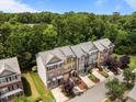 Beautifully designed townhomes showcasing a peaceful community surrounded by a canopy of lush trees at 276 Linden Park Ln, Cary, NC 27519