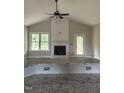 Bright living room featuring a fireplace, large window, and access to an outdoor deck at 2760 Rains Mill Rd, Princeton, NC 27569