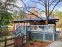 Inviting back deck with stairs and white chairs offers a relaxing outdoor space at 2907 University Dr, Durham, NC 27707