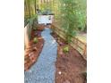 A stone walkway lined with mulch leads through a private backyard at 2907 University Dr, Durham, NC 27707