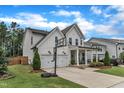 Beautiful home featuring a two-car garage, basketball hoop, and well-maintained lawn at 3181 Zebroid Way, New Hill, NC 27562