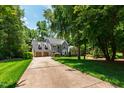 Inviting gray two-story home with an expansive driveway and lush green surroundings at 3304 Buck Run Trl, Wake Forest, NC 27587
