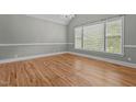 Bright bedroom boasting gleaming hardwood floors, crown molding, and large windows offering ample natural light at 3600 Trail 23 St, Durham, NC 27707