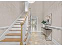 Inviting foyer with marble floors, staircase, chandelier, and elegant décor, creating a grand entrance at 3600 Trail 23 St, Durham, NC 27707