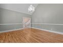 Inviting living room featuring gleaming wood floors, chandelier, and neutral color scheme providing an airy atmosphere at 3600 Trail 23 St, Durham, NC 27707
