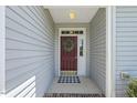 A welcoming front entryway, with a red door adorned by a wreath, leading into a charming home at 400 Indian Elm Ln, Cary, NC 27519