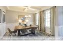 Dining room with coffered ceiling, modern chandelier, and large windows with patterned curtains at 409 Falls Bluff Dr, Wake Forest, NC 27596