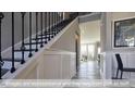 Bright hallway featuring stylish wall paneling and dark hardwood flooring at 409 Falls Bluff Dr, Wake Forest, NC 27596