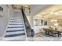 Elegant staircase with dark wood treads, white risers, and ornate iron railing at 409 Falls Bluff Dr, Wake Forest, NC 27596
