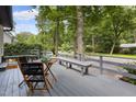 Outdoor deck with table, chairs and bench seating overlooking lush greenery and quiet street at 418 Ridgefield Rd, Chapel Hill, NC 27517