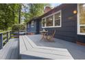 Outdoor deck featuring built-in bench seating, small table and ample space for entertaining at 418 Ridgefield Rd, Chapel Hill, NC 27517