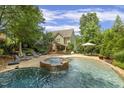 A private backyard oasis with a pool, hot tub, and patio perfect for relaxation and entertaining at 4221 Bibleway Ct, Holly Springs, NC 27540