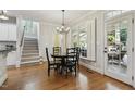 Cozy dining area with hardwood floors, a chandelier, and access to an outdoor patio at 4221 Bibleway Ct, Holly Springs, NC 27540