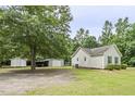 Large backyard features storage sheds, mature trees, and plenty of space at 436 Madison Ave, Princeton, NC 27569