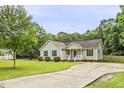 Well-maintained home featuring a long driveway and lush green lawn at 436 Madison Ave, Princeton, NC 27569