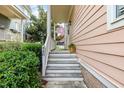 Inviting entryway with classic stairs and a cozy porch, enhanced by lush greenery and the house number 440 at 440 Heritage Village Ln, Apex, NC 27502