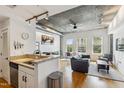 Bright living area featuring hardwood floors, concrete ceilings, and lots of natural light at 444 S Blount St # 209, Raleigh, NC 27601