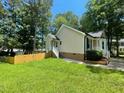 Lovely home with a fenced yard, complemented by a well-maintained lawn and mature trees at 5 Sue Ann Ct, Durham, NC 27704