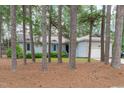 Charming single-story home with a well-maintained lawn, light grey siding, and a two-car garage surrounded by mature trees at 502 Hillcrest Rd, Apex, NC 27502