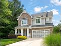 Charming home with stone and siding, a covered porch, and a two-car garage at 508 Morning Oaks Dr, Holly Springs, NC 27540