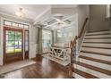 Elegant foyer featuring hardwood floors, a decorative ceiling, and staircase at 508 Morning Oaks Dr, Holly Springs, NC 27540