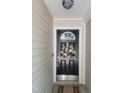A black front door with a wreath and a keypad lock provides a secure entry at 5126 Thornton Knoll Way, Raleigh, NC 27616