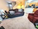 Comfortable living room area featuring a plush sofa and a cozy recliner at 5126 Thornton Knoll Way, Raleigh, NC 27616