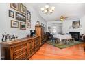Cozy dining room with wood floors, large dresser, and a fireplace at 513 Dragby Ln, Raleigh, NC 27603