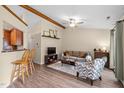 Comfortable living space featuring wood floors, wooden ceiling beams, and an open layout to the kitchen at 5801 Hadrian Dr, Durham, NC 27703