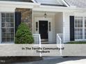 Close-up of the front porch with stone accents and a black front door at 603 Red Cedar Cir, Durham, NC 27712