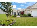 Attractive single-story house with a well-maintained lawn, garden, and a welcoming entrance at 610 Mixboro Dr, Cary, NC 27519