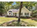 Exterior view showcasing the home's curb appeal with lush front yard at 6129 Krandon Dr, Raleigh, NC 27603