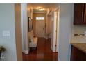 Hallway featuring hardwood floors, a decorative bench, and neutral paint at 825 Fulworth Ave, Wake Forest, NC 27587
