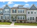 Charming townhome featuring a stone foundation, neutral siding, and manicured front lawn at 937 Baldwin Ridge Rd, Apex, NC 27523