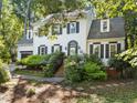 Traditional two-story home with brick stairs leading to the front door and a driveway with a basketball hoop at 1 Gatesway Ct, Durham, NC 27707