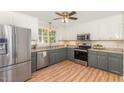 Well-equipped kitchen with stainless steel appliances, white cabinets, and a window above the sink at 101 Abram Way, Clayton, NC 27520