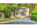 Charming two-story home featuring a brick and siding exterior, attached garage, and a lush landscaped yard at 105 Walter Hagen Dr, Mebane, NC 27302