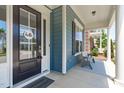 Inviting front porch with cozy seating, complemented by the home's blue siding and white trim at 1108 Lowland St, Apex, NC 27523