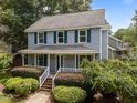 Charming two-story home featuring a classic design, covered porch, and well-maintained landscaping at 112 Autumn Ridge Dr, Knightdale, NC 27545