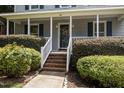 Inviting front porch with brick steps and lush landscaping surrounding the entrance at 112 Autumn Ridge Dr, Knightdale, NC 27545