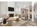 Bright living room featuring a fireplace with marble hearth, vaulted ceilings, and modern decor at 112 Solstice Cir, Cary, NC 27513