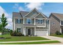 Attractive two-story home with a well-maintained lawn and integrated two-car garage at 1214 Valley Dale Dr, Fuquay Varina, NC 27526