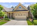 Home with a brick facade, attached two-car garage, and manicured landscaping at 122 Glenpark Pl, Cary, NC 27511