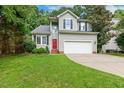 Charming two-story home with gray siding, black shutters, and an attached two-car garage at 12620 Waterlow Park Ln, Raleigh, NC 27614