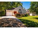 Inviting single-story home with a red front door, attached garage, and lush front lawn at 13 Boxwood Dr, Durham, NC 27713