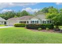 Charming single-story home featuring a well-manicured lawn, attached garage, and lush landscaping at 131 Abacos Ct, Clayton, NC 27520