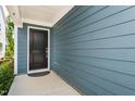 Inviting entrance with a black front door, siding and a concrete patio at 1363 Brown Velvet Ln, Apex, NC 27523