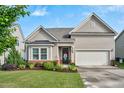 Charming home with a well-manicured lawn and attached two car garage at 1409 Sage Tree Dr, Zebulon, NC 27597